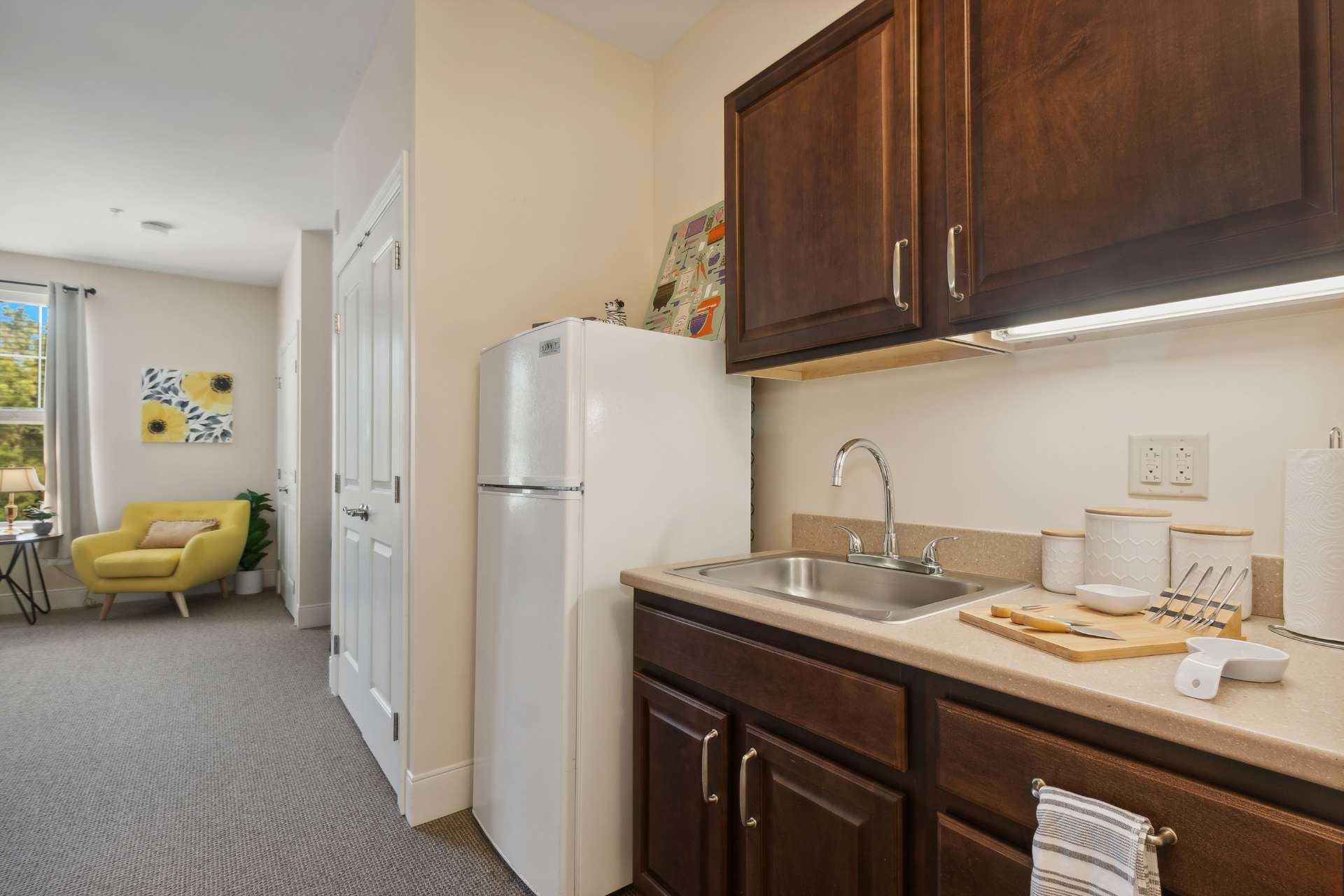 A private fridge and kitchen sink.