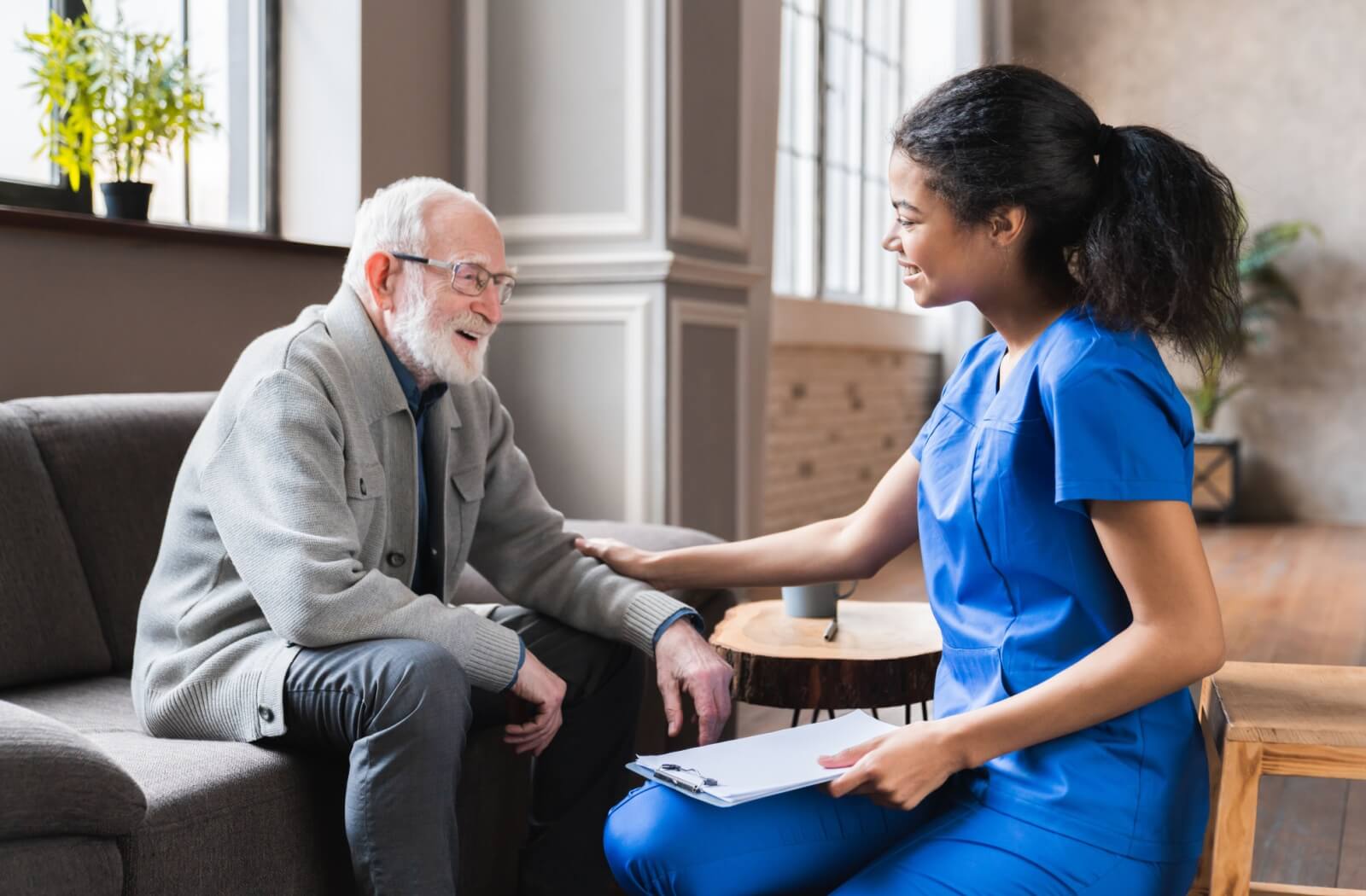 A respite care staff checking in on a senior resident