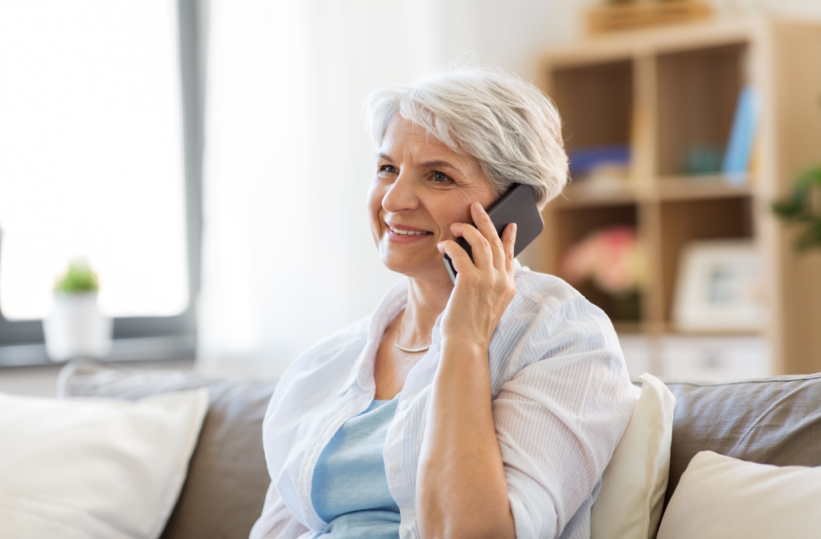 Older woman smiling and talking on a cell phone